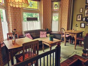 a living room with a couch and tables at Villa Warempel in Valkenburg