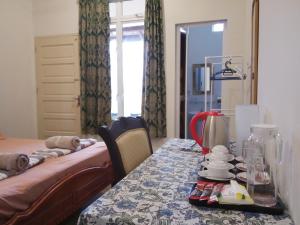 a room with a table with a bed and a table sidx sidx sidx at KC Beachfront in Marang