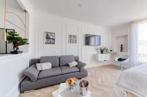 a living room with a couch and a table at La Croisette - Studio Concord Miramar in Cannes