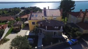 an aerial view of a large house with the ocean at Apartments Apartim Piran in Piran