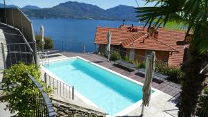 a swimming pool with a view of the water at Villa Paradiso in Cannero Riviera