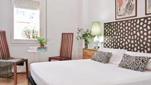 Ein Bett oder Betten in einem Zimmer der Unterkunft BizFlats Garden House