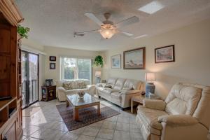 a living room with couches and a ceiling fan at Anna Maria Island Beach Bay Breeze in Bradenton Beach