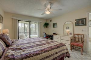 a bedroom with a bed and a desk and a ceiling fan at Anna Maria Island Beach Bay Breeze in Bradenton Beach +40 photos