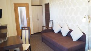 a living room with a couch with pillows on it at Czarna Perła in Ostrowo