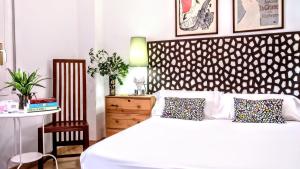 Ein Bett oder Betten in einem Zimmer der Unterkunft BizFlats Garden House