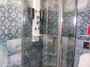 a bathroom with a shower with a glass door at ALEXYS TOP RESIDENCE in Mamaia Sat/Năvodari +9 photos