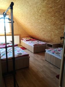 a room with three bunk beds in a attic at Słoneczne Zacisze in Miłomłyn