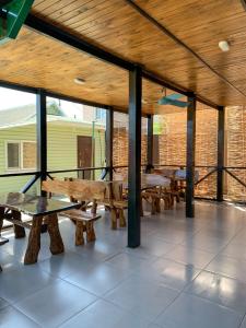 a deck with benches and tables on a building at Мини-отель Sunrise-Bugaz in Zatoka