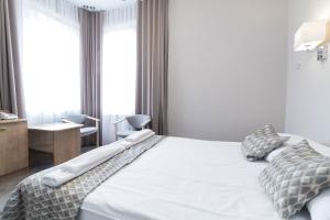 Postel nebo postele na pokoji v ubytování Hotel Jan Sander