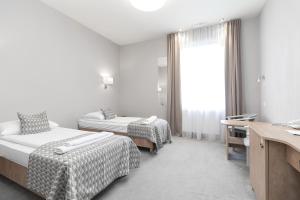 Postel nebo postele na pokoji v ubytování Hotel Jan Sander