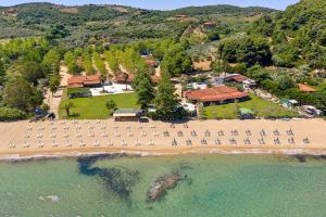 an aerial view of a beach with a group of chairs at Komitsa Luxury Apartments in Nea Roda