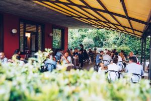 a group of people sitting at tables in a restaurant at Il Leone D'Oro in Telgate