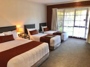 a hotel room with two beds and a window at Ararat Colonial Lodge Motel in Ararat