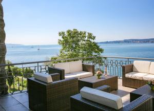 a balcony with chairs and a view of the water at Bad Hotel Überlingen in Überlingen