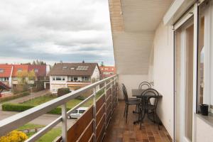 a balcony with a table and chairs and a view at Ferienwohnung Gehring Bad Krozingen in Bad Krozingen