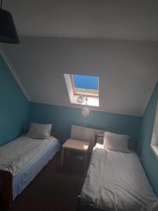 a small room with two beds and a window at Noclegi w Kudowie in Kudowa-Zdrój +3 photos