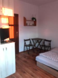 a room with a bed and a table and chairs at Agroturystyka na Górce in Nowa Wies +34 photos