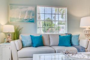 uma sala de estar com um sofá com almofadas azuis em A Suite Retreat em Miami