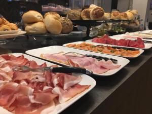 a buffet with many plates of food on a table at Charmehotel Kruishof in Ostend