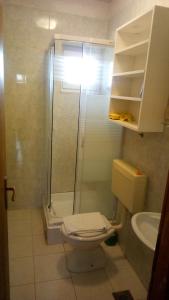 a bathroom with a shower and a toilet and a sink at STUDIO APARTMANI KIKI in Srima +35 photos