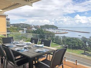 a table on a balcony with a view of the water at Classic View 1, 1 49 Victoria Parade - panoramic water views, aircon and Wifi in Nelson Bay