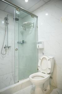 uma casa de banho com um WC e uma cabina de duche em vidro. em Hanoi Asia 2 Long Bien em Hanói