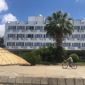 a person riding a bike in front of a building at VİLLA FUAT in Erdek