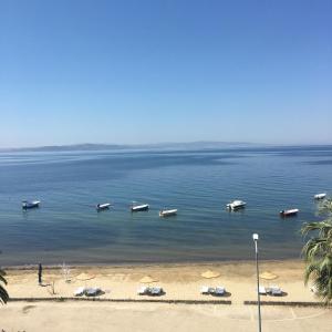 a group of boats in the water on a beach at VİLLA FUAT in Erdek