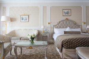 a hotel room with a bed and a couch at The State Hermitage Museum Official Hotel in Saint Petersburg