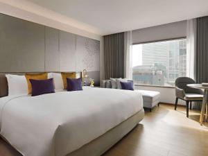 A bed or beds in a room at Hotel Windsor Suites Bangkok