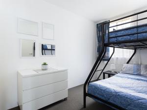 a bedroom with a bunk bed and a dresser at Collendina 4 fantastic water views and sea breezes in Nelson Bay