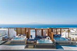 a resort with two swimming pools and the ocean at 3 Elements by Stylish Stays in Oia