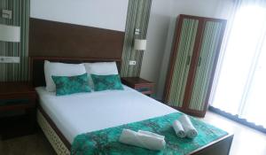 a bedroom with a large bed with towels on it at Nehir Dalyan Boutique Otel in Ortaca