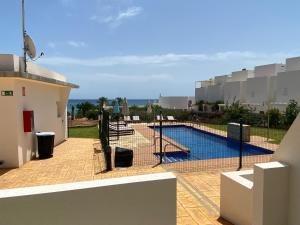 a view of a swimming pool from the balcony of a house at Mda Playa del Cantal in Mojácar