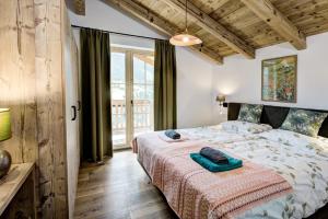 a bedroom with a bed with a blanket on it at Königshaus by Alpin Bookings in Mühlbach am Hochkönig