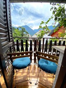two chairs on a balcony with a view of the mountains at Holiday Home Kristi in Bovec