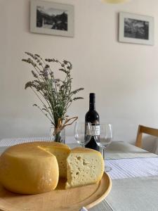 a plate of cheese and a bottle of wine on a table at Holiday Home Kristi in Bovec