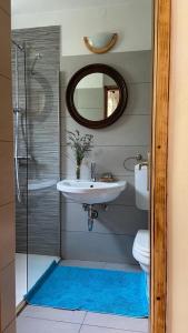 a bathroom with a sink and a toilet and a mirror at Holiday Home Kristi in Bovec