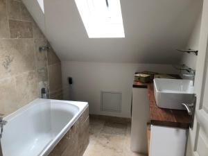 a bathroom with a bath tub and a sink at Taboo Treigny in Treigny
