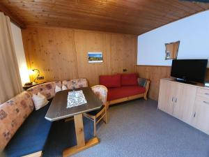 a living room with a couch and a table at Apartment Rauch in Zell am Ziller