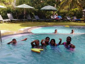 a group of people in a swimming pool at The Nature Park Villa in Sigiriya