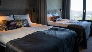 Säng eller sängar i ett rum på Hotell Södra Berget