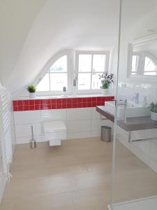 a bathroom with two sinks and a glass shower at Haus Elve in Zierow