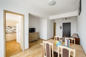 a kitchen and dining room with a table and chairs at Sunny View 2 Bedroom Central Apartment in Oradea