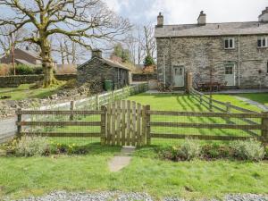 a wooden fence in front of a house at Oak Tree Cottage in Coniston