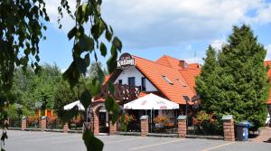 a restaurant with an orange roof at Stara Kuźnia Mazurska in Węgorzewo