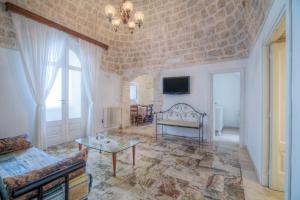 a living room with a couch and a table at Trulli La Piazzetta by Rentbeat in Cocolicchio