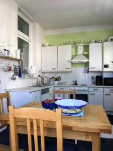 a kitchen with a wooden table with a bowl of fruit on it at FeWo Seagull in Warnemünde