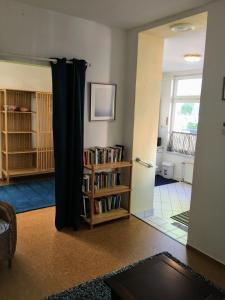 a living room with a door and a book shelf at FeWo Seagull in Warnemünde